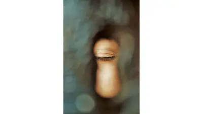 Closed eye through a key hole