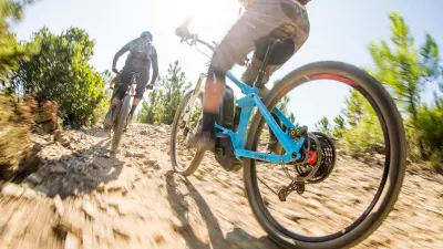 Two people riding eBikes 